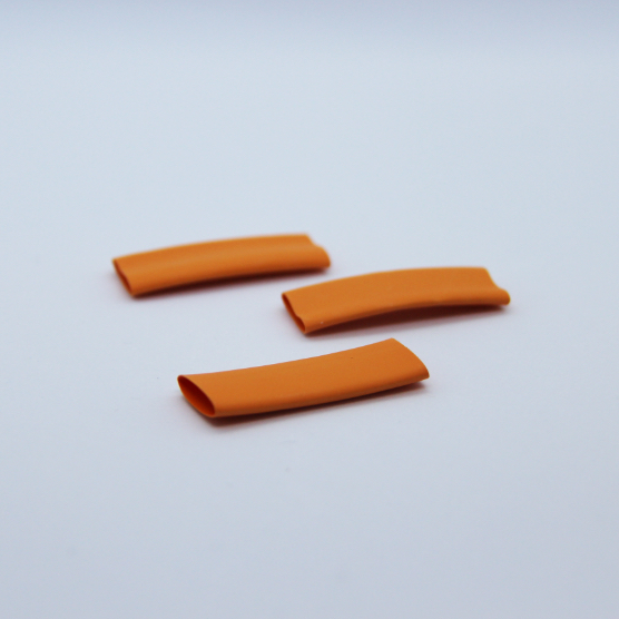 3 pieces of orange heat-shrink on a white background