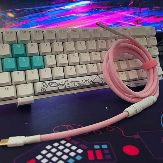 USB cable on a desk with a keyboard in the background