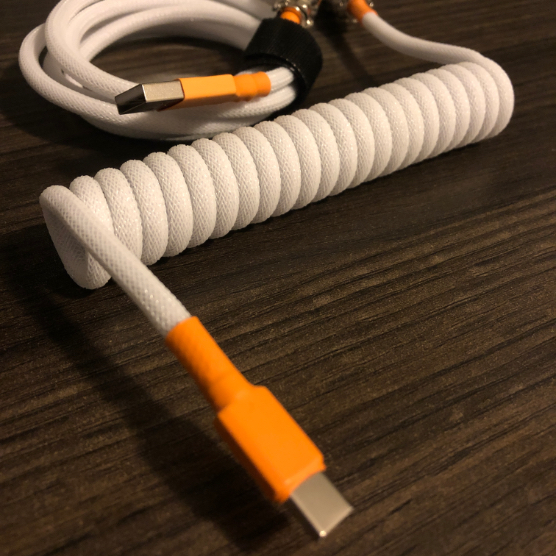 close up of a orange and white USB cable