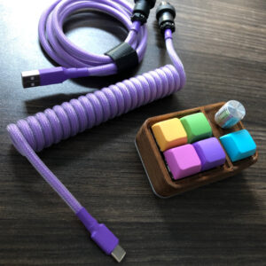 purple coiled USB cable and colourful macro pad on a wooden table