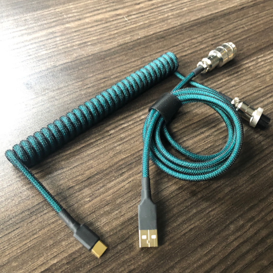 Coiled USB cable in green on a wooden desk